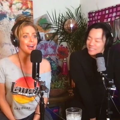 They both are wearing a black headphone with mic Infront of them.